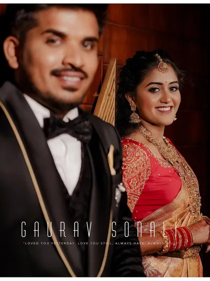 A beautiful portrait of the couple at their reception. The groom is out of focus in the foreground, creating an artistic shot that draws attention to the bride's happy expression.