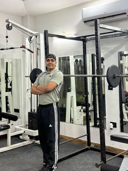Standing by the squat rack.