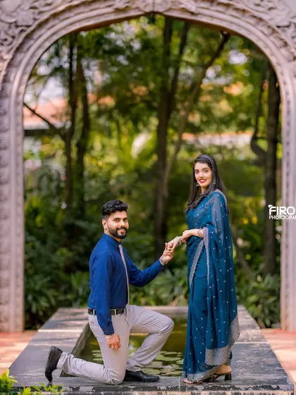 A classic proposal pose in a beautiful garden setting. The archway and fountain create a timeless and romantic backdrop for this special moment.