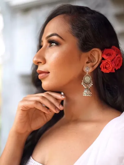 A close-up profile view showcasing the sharp winged eyeliner and glowing skin. This highlights my focus on creating a clean, polished finish that looks stunning from all angles.