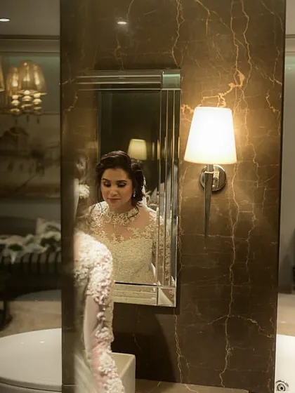 The bride taking a final look in the mirror, looking confident and beautiful.