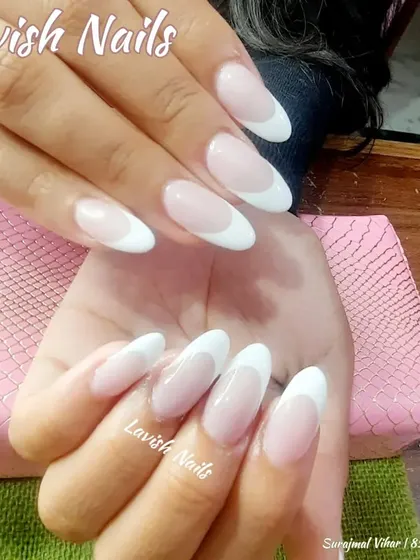 A classic French manicure on almond-shaped nails, a universally flattering and sophisticated choice for any bride.
