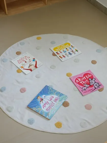 A cozy reading mat with a selection of books, an inviting space for children to relax and read.