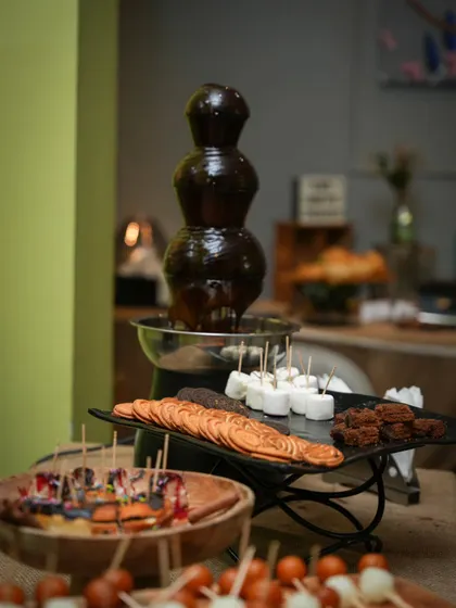 A wider view of our dessert station, featuring the popular chocolate fountain and a variety of other sweet skewers and treats to dig into.