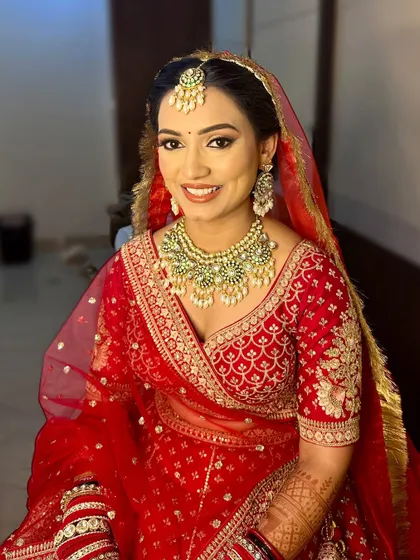 A traditional finish for Aditi. Her look features clean lines, a classic bindi, and a bright smile, embodying the timeless Indian bride.