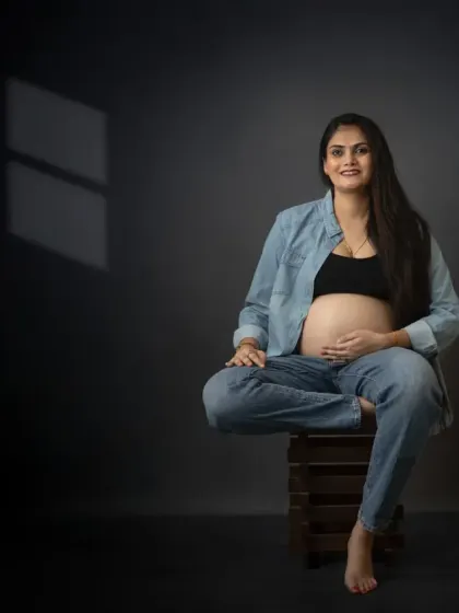 Modern motherhood has a style all its own. This maternity portrait captures a moment of quiet confidence with a contemporary denim look, proving that pregnancy photos can be both classy and cool.