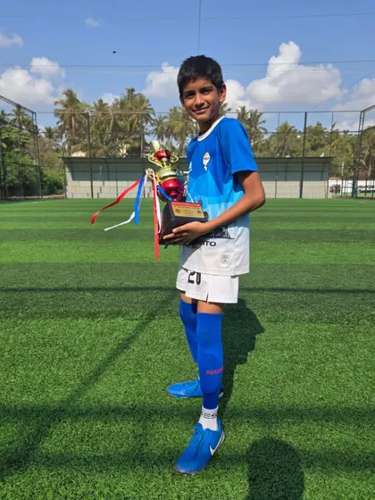 A young champion from our U12 team with his trophy.