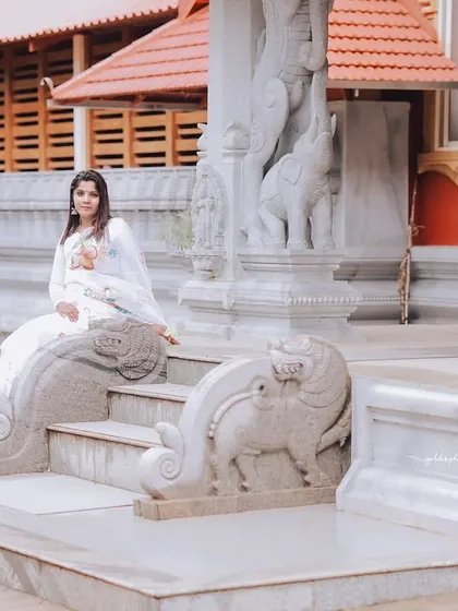 A series of peaceful portraits taken at a temple. The model's white saree contrasts beautifully with the intricate stone architecture, creating a sense of calm and serenity.