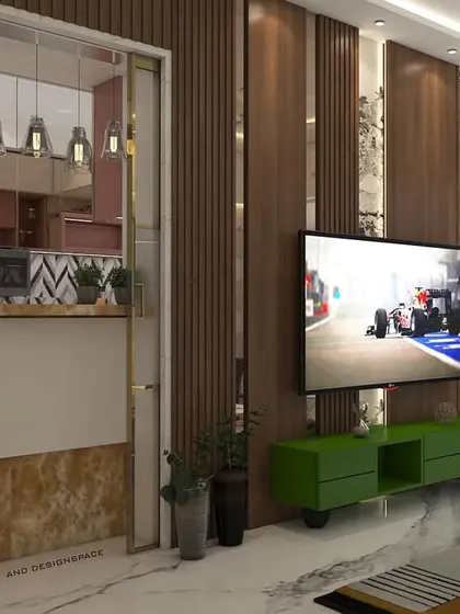 A design concept showing an open-plan living and kitchen area. A breakfast counter with a marble-finish base acts as a subtle divider between the kitchen and the living room's TV and seating zone.