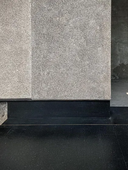 A mock-up detail at the Courtyard House, testing the junction between the black stone flooring and the grey granite wall panels. Precision in these details is something we obsess over.