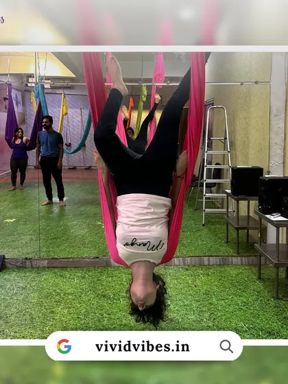 Aerial yoga is a mental practice too. This image shows a student in a deep inversion, a pose that requires focus and trust.
