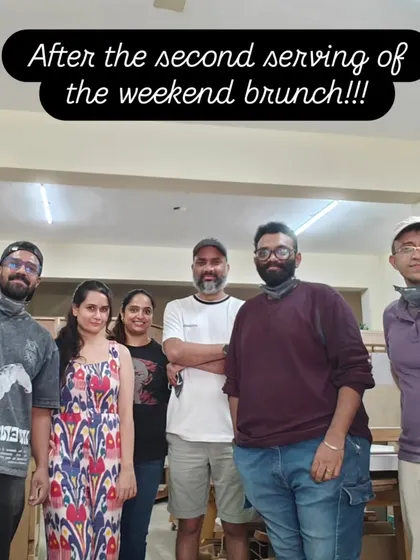 The happy crew after a full weekend of woodworking. Everyone is holding up the projects they completed, feeling accomplished and ready for a rest.