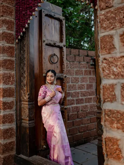 A beautiful bride framed by a traditional doorway. We use architectural elements and natural light to create artistic and striking portraits that highlight her grace.