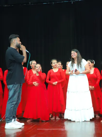 Sharing a laugh with a group of dancers in red. It's the small, genuine interactions that make an event special.