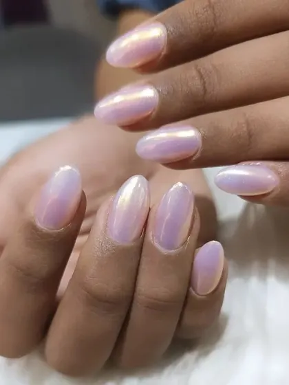 An iridescent chrome finish that shifts between pink and gold, giving these almond nails a magical, pearly look.