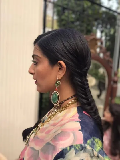 A sleek and modern fishtail braid. This is a great option for a daytime event like a mehendi or haldi, keeping the hair neat while still being stylish.