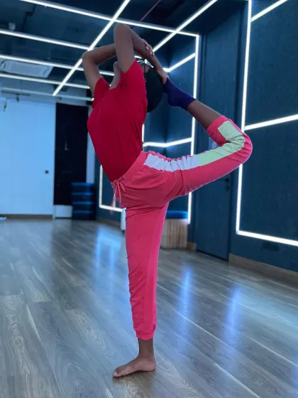 This student holds a graceful dancer's pose, showing the progress she has made in flexibility and balance.