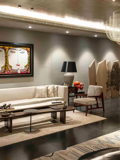 In the formal living room, a large Thangka-style painting provides a powerful cultural anchor. Placed in a contemporary setting with minimalist furniture, the traditional artwork becomes a statement piece that bridges eras.
