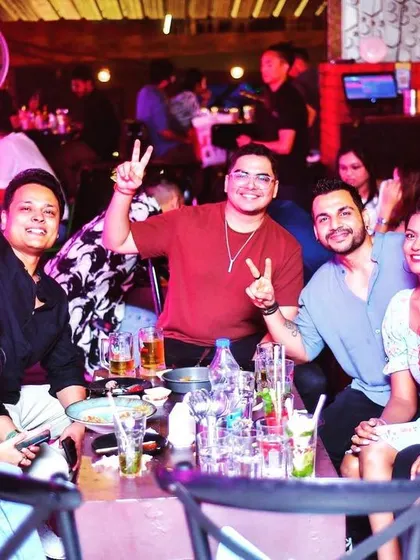 Cheers to the weekend. A group enjoying drinks and good company at their table.
