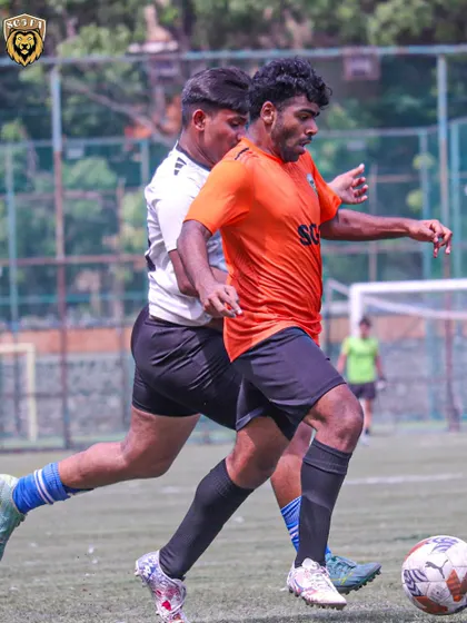 A player holding off a defender, showing the physical strength we build in our athletes.