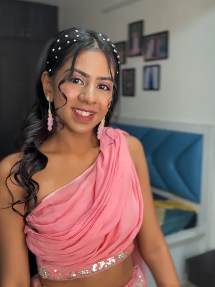 A full-face view showing her radiant smile and the pretty pink tones of her makeup.