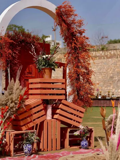 Another angle of the crate installation, showing the beautiful combination of painted wood, dried foliage, and ceramic vases.