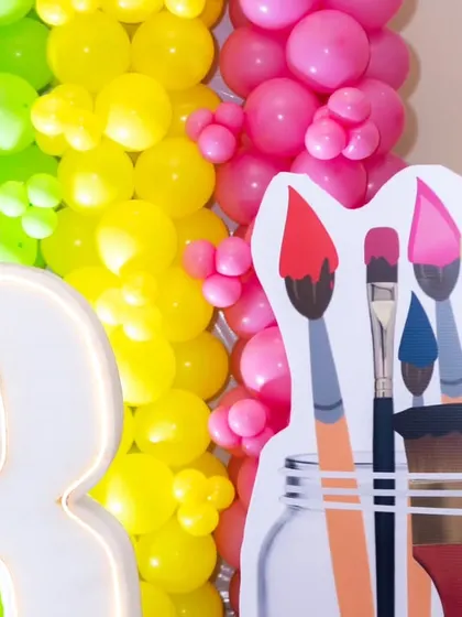 A light-up marquee number '3' next to a paintbrush cutout, adding a special touch to the Art & Paint birthday theme.