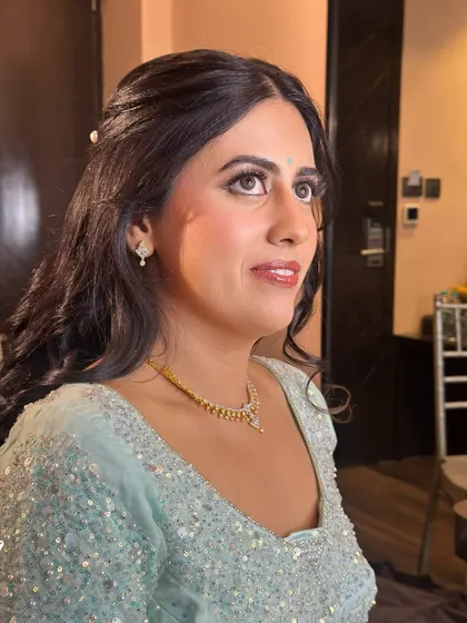A look of happy anticipation. The soft glam makeup enhances her features, creating a look that is both polished and effortlessly beautiful.