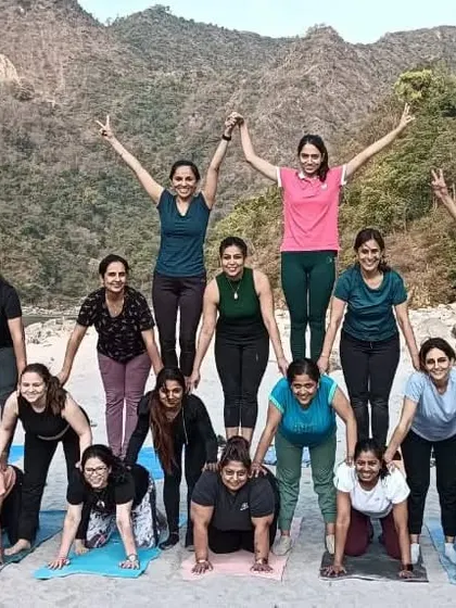 A human pyramid of yogis. Our community bond is built on trust, support, and a lot of fun.