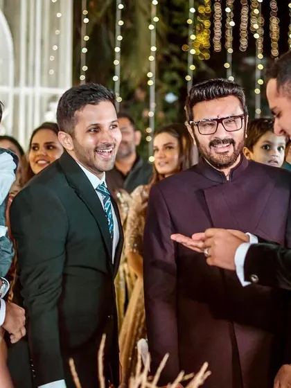 The groom's family shares a laugh as the ring mystery is solved. A great candid moment of family fun.
