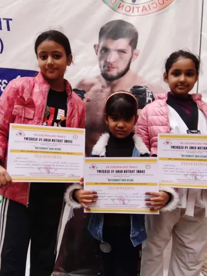 Three of my young female students proudly displaying their certificates. I train girls to be strong and self-reliant warriors.