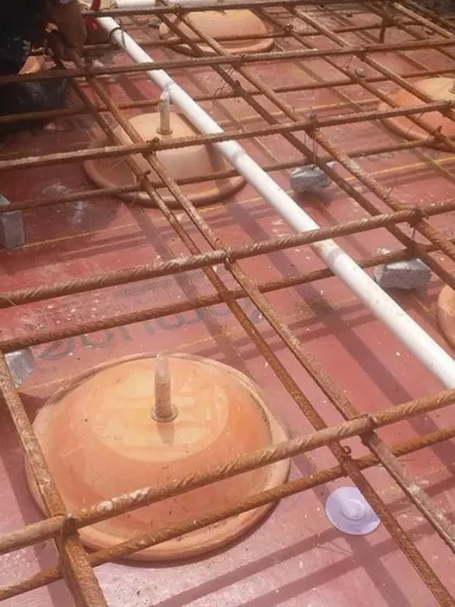 The underlying structure of the People Tree House ceiling, with rebar laid over the earthen pots before the concrete is poured.