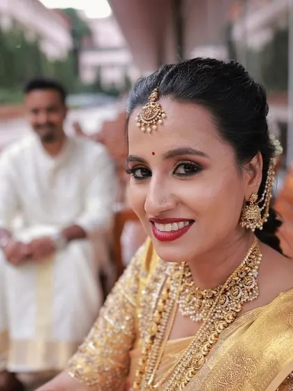 A bright, happy close-up. Her smile is the centerpiece, enhanced by a classic red lip and subtly defined eyes.