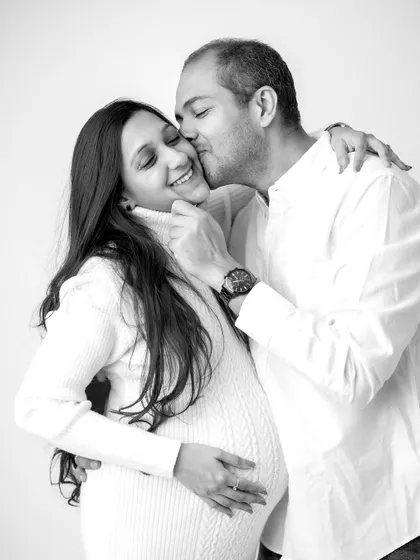 A sweet kiss and a happy smile. I love capturing these candid moments of affection between partners during a maternity shoot.