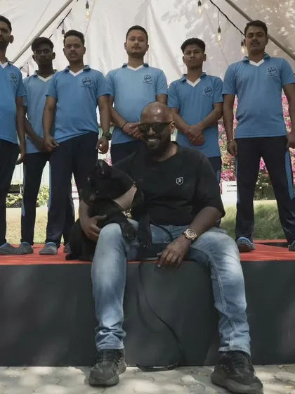 Posing with my team and one of my dogs. It takes a dedicated team to run a successful board and train facility and give every dog the attention it needs.