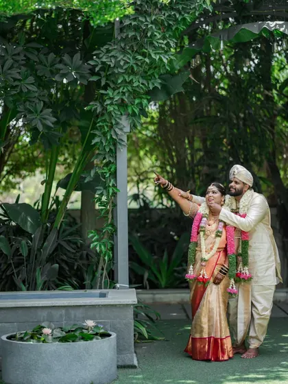 A candid moment of the couple looking up at something together, sharing a moment of wonder during their wedding day.