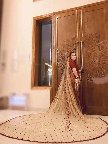 A breathtaking shot of the bride and her magnificent long-trailed lehenga, a true statement of bridal grandeur.