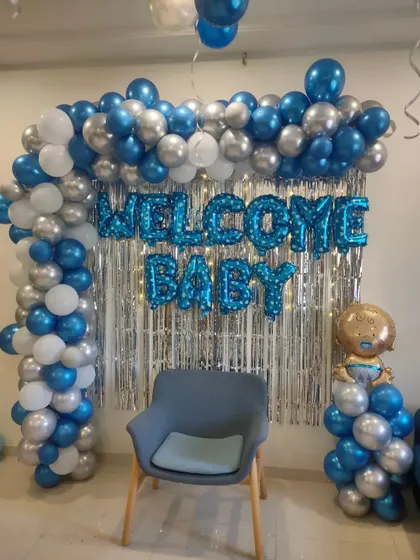 Another view of the blue and silver 'Welcome Baby' backdrop, perfect for a small home celebration.