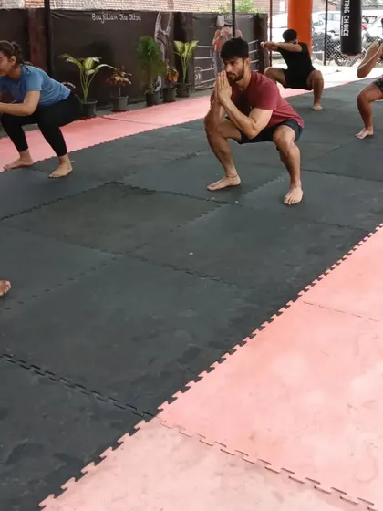 A group of members doing squats during a warm-up at our Sector 141 club. The open space is perfect for group fitness and conditioning.