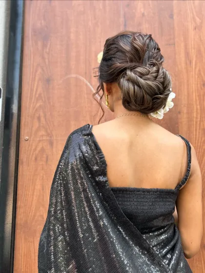 A full view of the model wearing the textured bun, showing how it complements a modern saree.