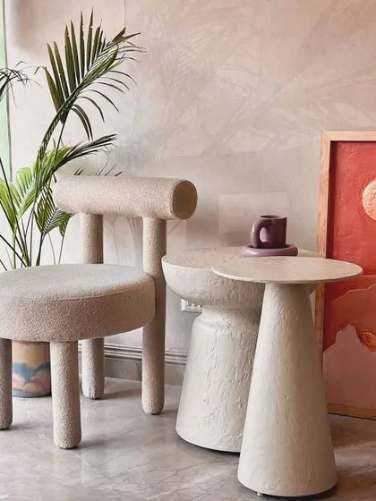 A myriad of textures in one corner. This image features our textured, wabi-sabi inspired side tables paired with a bouclé chair, creating a mood that is both organic and modern.