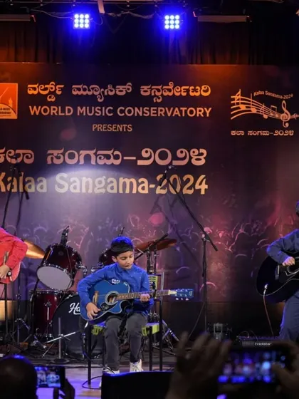 Our young guitar trio on stage, paying a heartfelt instrumental tribute to the legendary Puneeth Rajkumar. This performance showcases their coordination and the emotional depth they bring to their music.