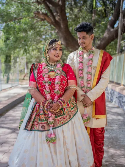 An elegant portrait of the couple in their vibrant traditional outfits, perfect for a classic wedding album.
