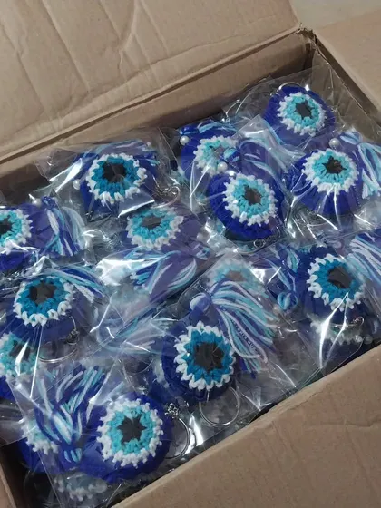 A box of 100 evil eye keychains, all packed and ready to be shipped to a client in Mumbai. I ensure every piece is perfect before it leaves my workspace.