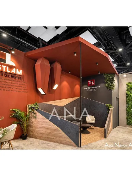 A dedicated meeting nook within the Trustlam '23 pavilion, set against a backdrop of geometric panels and a living wall. This space offered a semi-private area for discussions within the open-plan design.