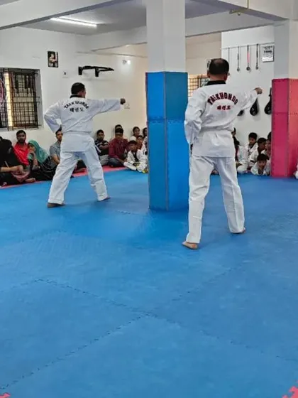 Two senior students demonstrate a form.