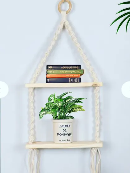 This macrame hanging shelf is a stylish, space-saving solution for displaying your plants and books in smaller homes or apartments.