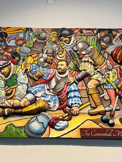 A close-up of the painted mural, focusing on the central character and the expressive faces of the surrounding soldiers.