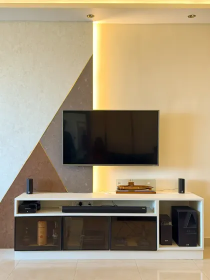 The TV wall in this living room is enhanced with automated backlighting. This not only looks great but also reduces eye strain during late-night viewing.