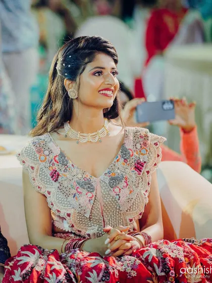 A close-up of Rishika's happy expression. The makeup enhances her features beautifully.
